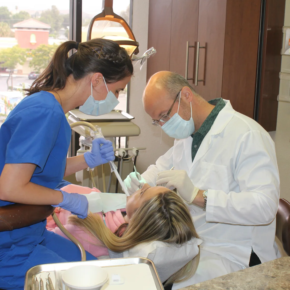 Dr. Kosta and his dental assistant treating a patient at Konstantinos Proussaefs DDS Inc