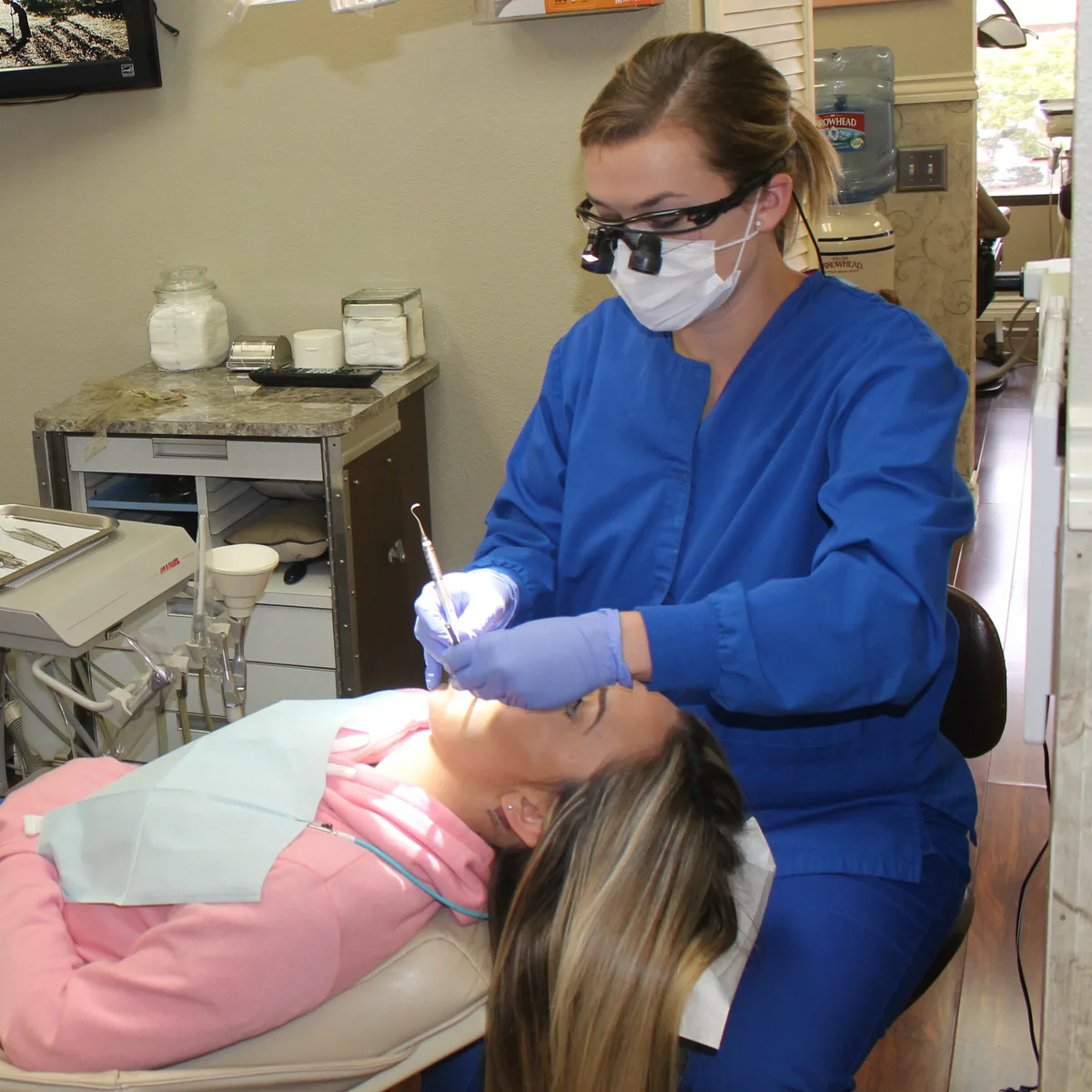 Dental hygienist providing a cleaning at Konstantinos Proussaefs DDS Inc